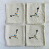 Fronts of folded cocktail napkins aranged in a grid