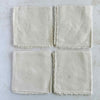Backs of folded cocktail napkins aranged in a grid