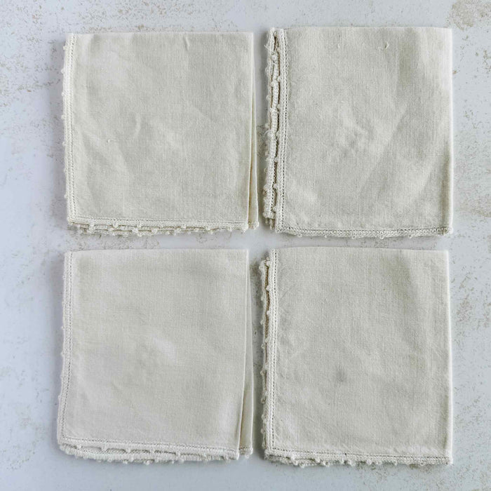 Backs of folded cocktail napkins aranged in a grid