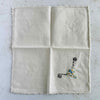 Front of unfolded cocktail napkin