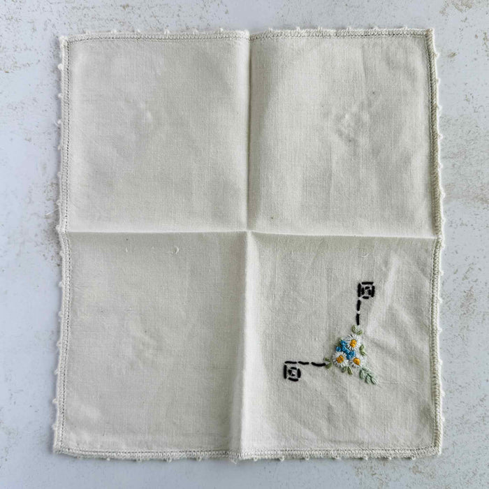 Front of unfolded cocktail napkin