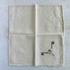 Front of unfolded cocktail napkin