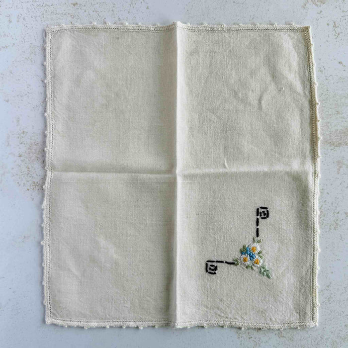 Front of unfolded cocktail napkin