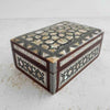 Three-quarter view of inlaid wood box with lid closed