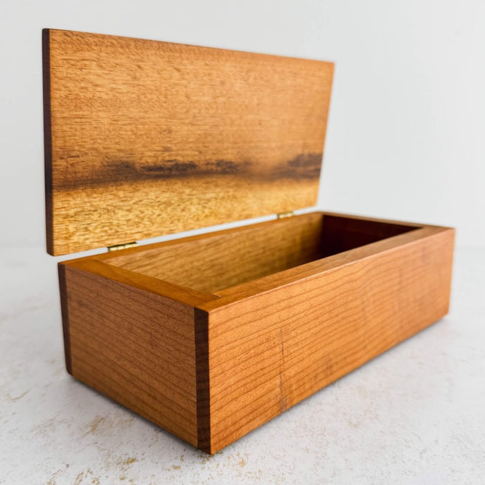 Three-quarter view of inlaid wood box with lid open