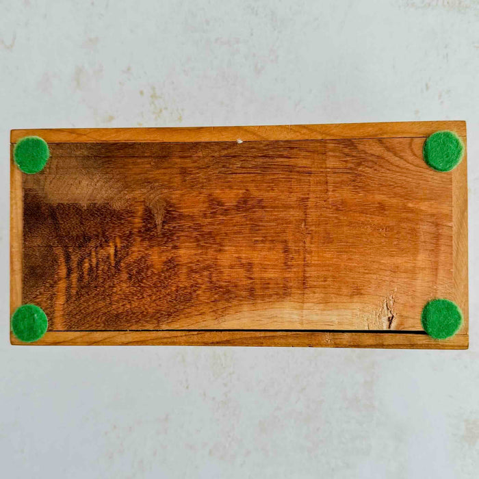 Underside of inlaid wood box showing green felt pads