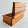 Three-quarter view of wood box with lid raised showing inlay