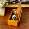 Vintage inlaid wood keepsake box displayed open with antique watches and small mementos showing interior storage