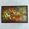 Top down view of vintage floral wood keepsake box lid decorated with flowers and wavy border