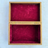 Inside ofvintage wooden box showing lid laying flat on surface and plum colored lining