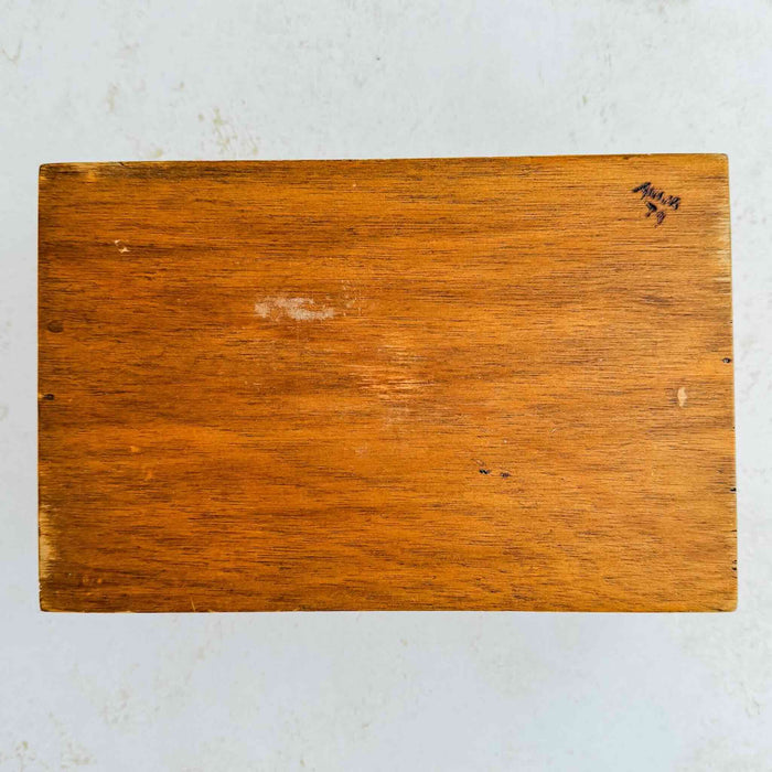 Underside of vintage floral wood keepsake box showing decorator's name and year
