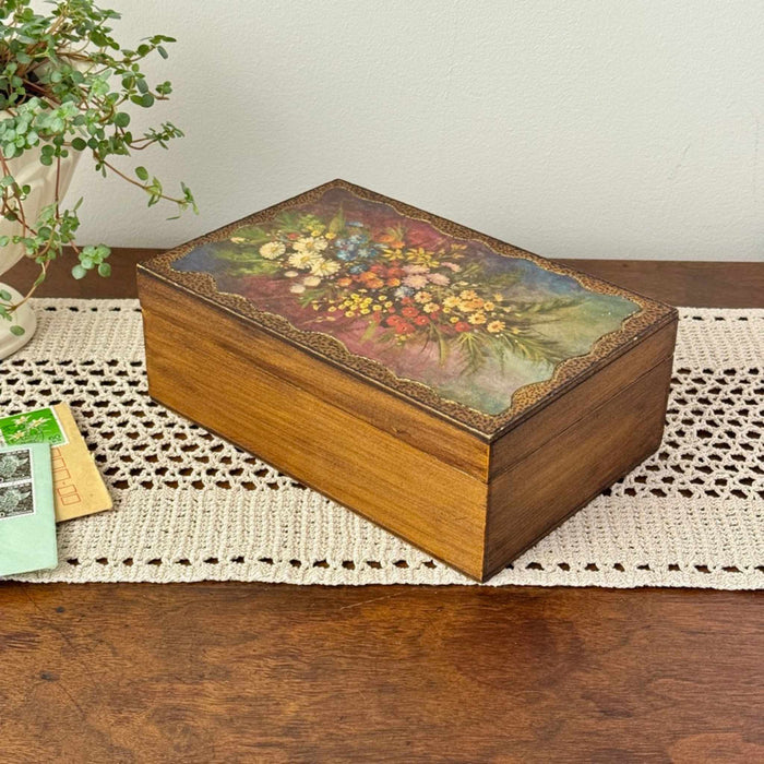 Vintage wood keepsake box with floral painted lid and warm wood sides, styled on a crochet runner with trailing plant and vintage letters