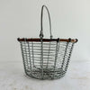 Three-quarter view of wire and twig basket