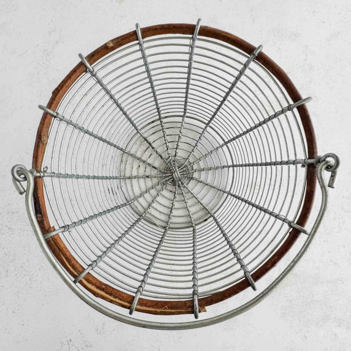 Top down view of top rim, handle, and inside of wire and twig basket