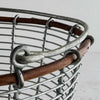 Close-up of opposite rim/handle connection on wire and twig basket