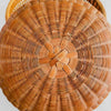 Close-up of woven basket lid showing areas of breakage