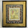 Framed embroidered fabric with floral and butterfly design on a light background