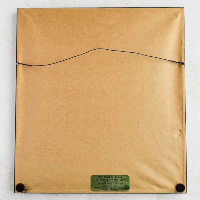 Back of framed embroidery showing brown paper, hanging wire, and label
