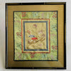 Framed embroidered fabric with floral and butterfly design on a light background