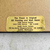 Close-up of gallery's gold label on back of framed embroidery