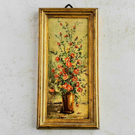 Vintage print of roses in a brown vase in a rustic gold frame
