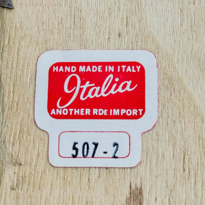 Close-up of numbered "Italia" label on back of floral still-life scene