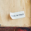 Close-up of Made in Italy label on back of floral still-life scene