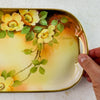 Right-hand side of antique yellow rose tray with hand for scale