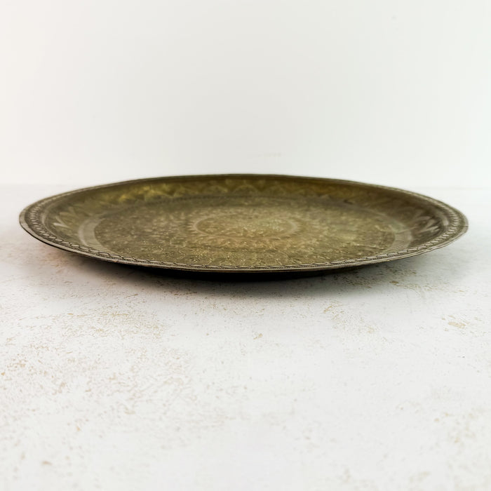 Side profile of the brass tray showing the shallow raised rim and approximately 3/4-inch depth