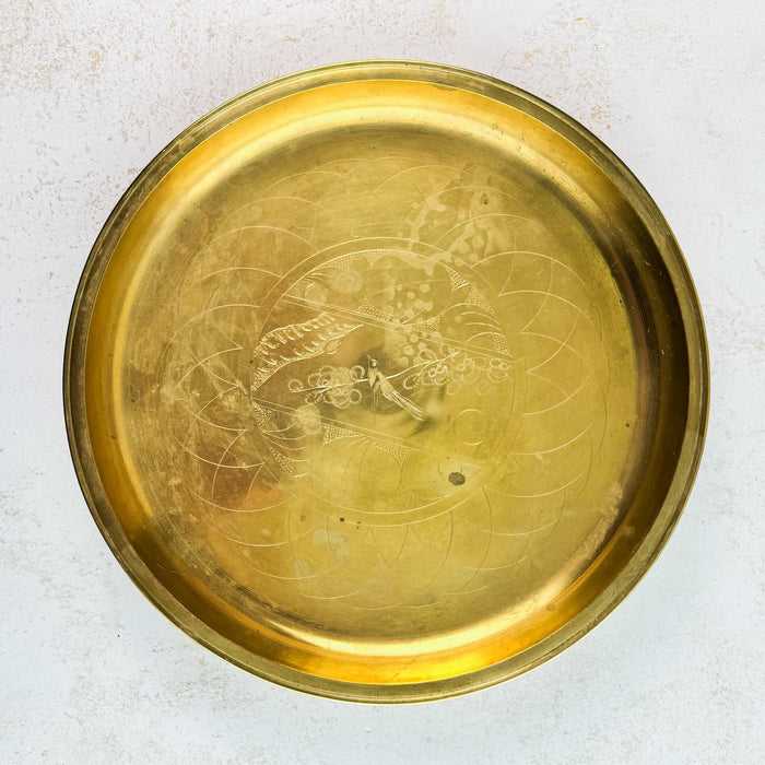 Full view of vintage engraved brass tray showing bird decoration and discolored surface areas