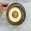 Angled view of brass bowl with hand for scale