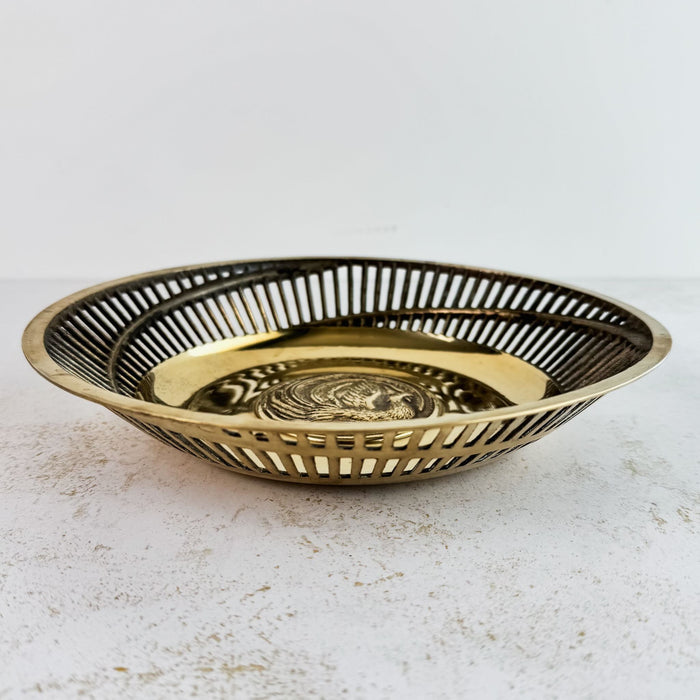 Side view of brass bowl with pierced sides and exotic bird center medalion