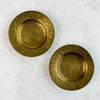 Two vintage brass trinket dishes with all-over floral and leafy scrollwork engraving, viewed from above, showing different radiating medallion patterns on each