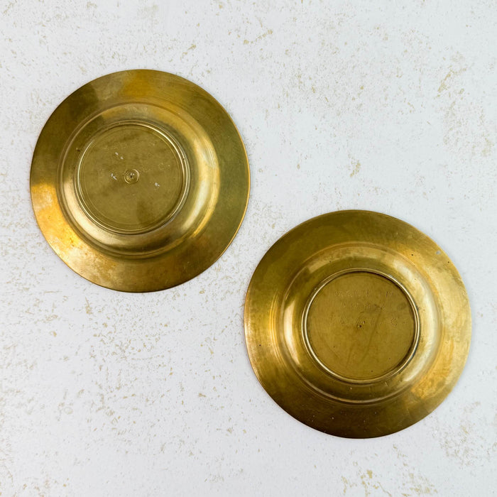 Back view of both small floral engraved brass dishes