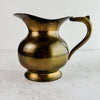 Full view of vintage brass pitcher with spout facing left