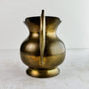 View of vintage brass pitcher with spout facing away