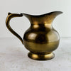 View of vintage brass pitcher with spout facing right