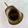 Top down view of vintage brass pitcher showing flared spout lip