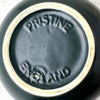 Close-up of the teapot base showing the molded PRISTINE and ENGLAND marks and unglazed foot rim