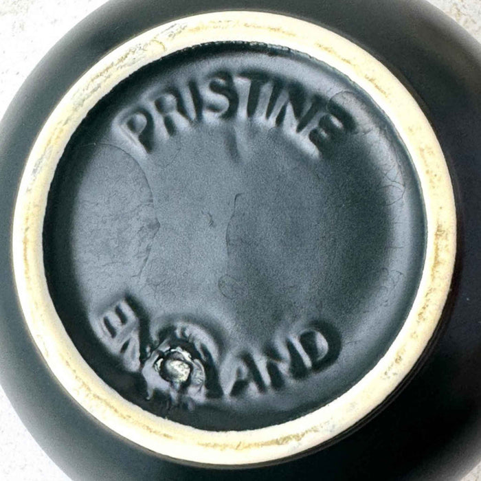 Close-up of the teapot base showing the molded PRISTINE and ENGLAND marks and unglazed foot rim