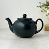 Matte black Pristine England teapot with rounded body, curved spout, loop handle, fitted lid, and ball finial