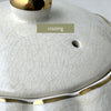 Vintage Gibsons Staffordshire England teapot lid, close-up showing age-related crazing in the ivory glaze.