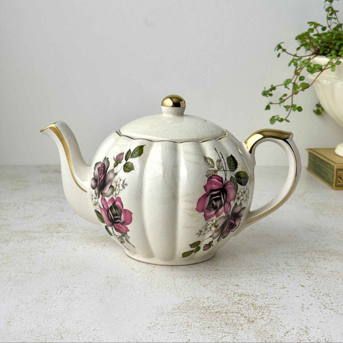 Vintage Gibsons Staffordshire England teapot with pink and black roses, fluted ivory body, and gold trim.