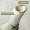 Close-up of the teapot spout showing a hairline crack and wear to the gilt rim with 'gilt wear' and 'spout hairline crack' text labels