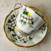Back view of Royal Albert White Dogwood teacup resting on its side on matching saucer