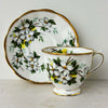 View of Royal Albert White Dogwood saucer standing behind matching teacup