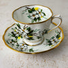 Angled view of Royal Albert White Dogwood teacup and matching saucer showing teacup interior decoration
