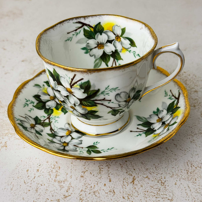Angled view of Royal Albert White Dogwood teacup and matching saucer showing teacup interior decoration