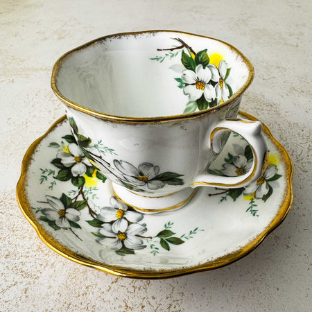 Three-quarter view of Royal Albert White Dogwood teacup and matching saucer