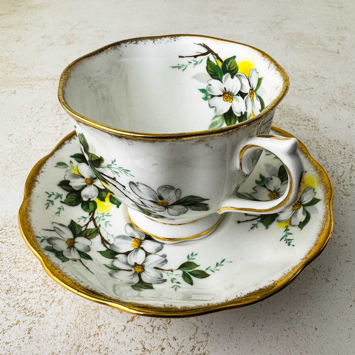 Three-quarter view of Royal Albert White Dogwood teacup and matching saucer